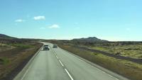 Cars-driving-on-road-in-iceland-near-lava-fields