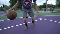 Pov-angle-of-person-dribbling-basketball