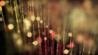 Loop of warm 4K bokeh lights and lines floating slowly on dark background 