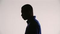 Silhouette-of-a-young-black-man-meditating-and-tilting-his-head-left-down-and-then-right-down