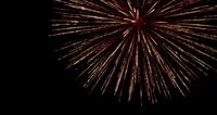 Yellow-and-red-fireworks-glowing-on-dark-sky-in-4k-slowmotion