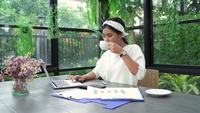 Young Asian woman working on laptop 