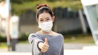 Woman puts on a nose cloth