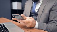 Middle-Aged Businessman Using Smartphone in The Office