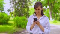 Young Businesswoman Reading a Book on A Smartphone