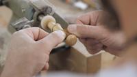 Woodworker Polishing a Wooden Part