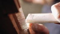 Hand Sanding a Wooden Comb