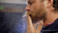Bearded Man Smokes a Cigarette