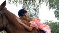 Girl Riding and Petting a Horse