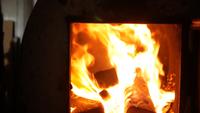Man Puts Firewood in The Oven
